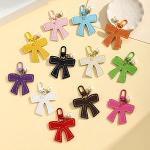 Handmade PU leather bow keychain with pearl pendant in twelve vibrant assorted colors