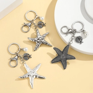 Ocean starfish keychain with silver textured pendants and white faux pearl charms