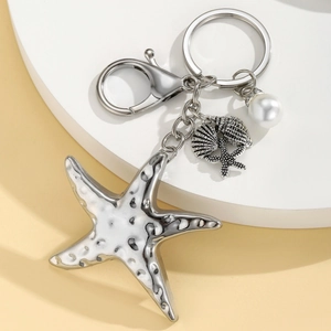 Bohemian silver starfish keychain with pearl and seashell charm on white display