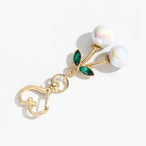 Creative cherry keychain with colorful pearlescent beads and green rhinestone leaves