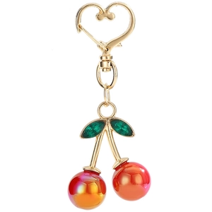 Cute iridescent cherry keychain with golden heart clasp and green rhinestone leaves