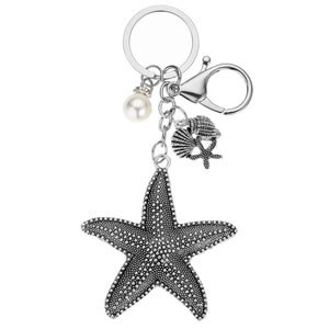Silver starfish keychain with white faux pearl and seashell charms on white background