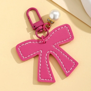 Exquisite rose red leather bow keychain with large faux pearl and metal clasp hanging