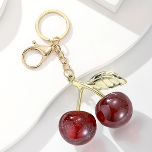 Detail of red glitter resin cherry keychain with gold leaves and lobster clasp hardware