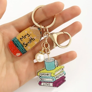 Detail of acrylic teacher keychain with pencil pendant and custom name engraving