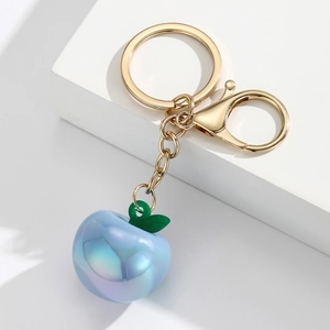 Detailed view of pearlescent light blue apple keychain with gold metal lobster clasp