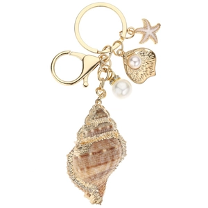 Golden sea shell and starfish keychain with pearl charms on a minimalist background