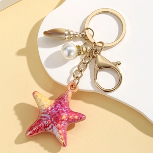 Colorful starfish keychain with imitation pearl and shell charm on golden metal ring