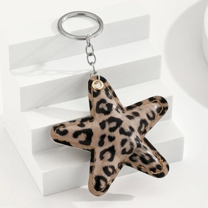 Close-up of leopard print star keychain with brown stitching and silver metal ring
