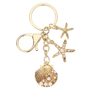 Golden ocean keychain featuring starfish, pearl shell charms, and starfish pendant on white