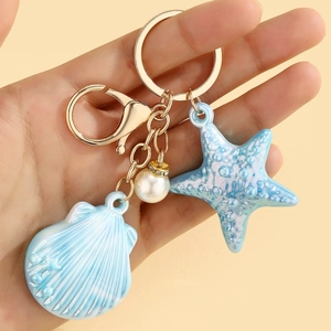 Charming ocean theme keychain with blue gradient shell, starfish and pearl accent