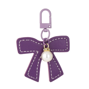 Purple leather bow keychain with pearl pendant and gold spring clasp on white background