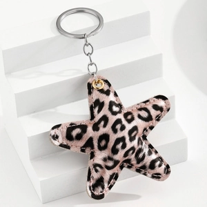 Detail of leopard print star leather keychain with gold eyelet and silver metal ring