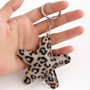 Handheld view of a stylish leopard print star keychain with metallic link chain