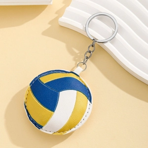 Détail d'un porte-clés volley-ball montrant les coutures en cuir et l'anneau en métal argenté