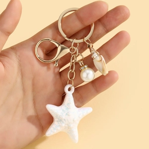 Colorful resin starfish keychain with pearl and seashell on a light gold plating keyring
