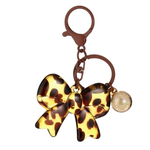 Leopard print acrylic bow keychain with brown metal carabiner and iridescent bead charm