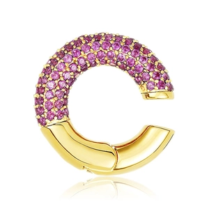 Detail of gold C-shaped ear cuff with purple cubic zirconia pavé and polished finish