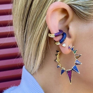 Detail of colorful crystal ear cuff set with 18k gold plating on a model's ear