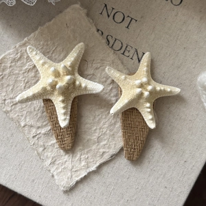 Detail of starfish hair clips with woven straw base and realistic matte texture