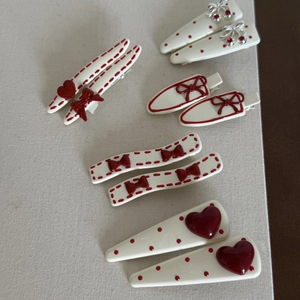 Detailed set of cream hair clips with red bows, polka dots, and cherry patterns