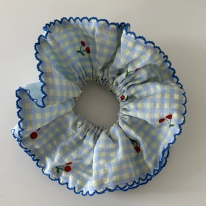 Blue gingham scrunchie with cherry print and wavy lace trim for women hair styling