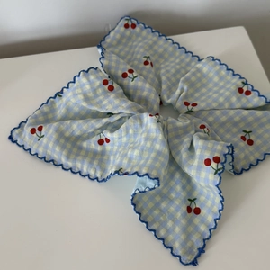Blue plaid scrunchie with red cherry print and navy blue scalloped trim edges