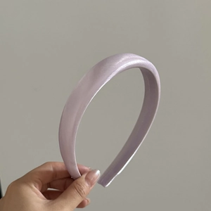Macro detail of lavender satin headband with thick sponge padding and silky texture
