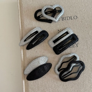 Glitter silver and black metal hair clips in heart and oval shapes for women