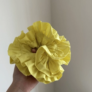 Bright yellow ruffled satin scrunchie with large double-layered ruched fabric design