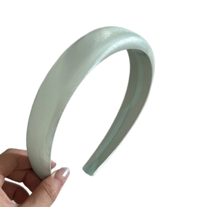 Elegant mint green padded satin headband with a smooth silk texture for a stylish look