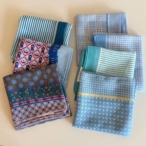 Variety set of blue checkered and floral printed headscarves for women on white background