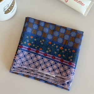 Detail of blue plaid floral printed headscarf showing rich texture and mixed pattern