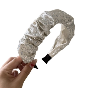 Elegant off-white satin headband with sparkling rhinestones in a gathered scrunchie style