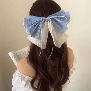French style blue polka dot bow hair claw with beige chiffon and beaded pendant detail