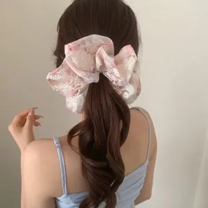 French mesh scrunchie with 3D floral embroidery for elegant ponytail styling