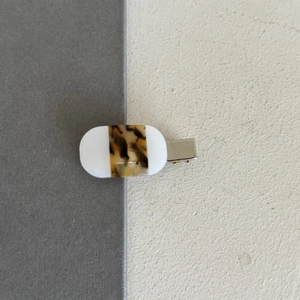 Detail view of French acetate hair clip with white and tortoiseshell pattern patchwork