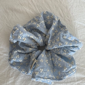 Sky blue oversized scrunchie with white floral embroidery and soft fabric texture
