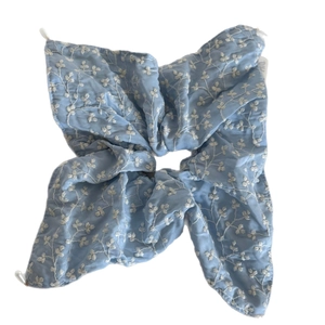 Oversized sky blue scrunchie with white floral embroidery and soft fabric texture