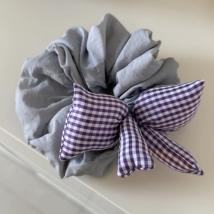 Grey fabric scrunchie with purple gingham bow tie accessory for women hairstyles