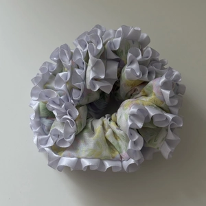 Floral print hair scrunchie with white ruffled edges and hydrangeas patterns for women