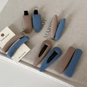 British style checkered fabric hair clip set in navy and beige with geometric shapes