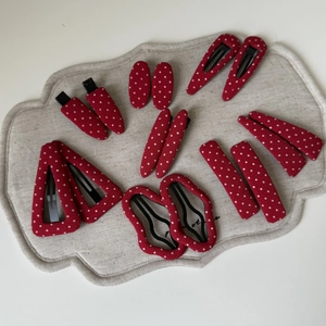 14-piece set of red and white polka dot fabric hair clips in various geometric shapes