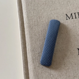 Detailed view of the blue diamond pattern fabric texture on the British style hair clip