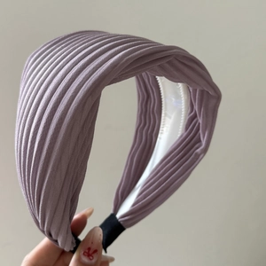 Lilac pleated wide headband with a minimalist design and textured fabric finish