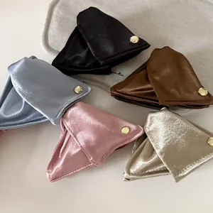 Detailed macro view of French style satin shell hair clips in five elegant assorted colors