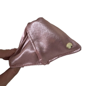 Elegant shell-shaped hair claw clip in pale pink satin fabric with gold metal button