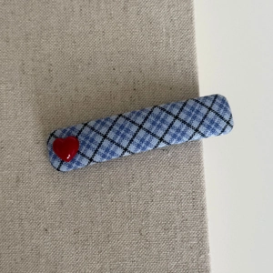 Blue and black plaid fabric hair clip featuring a red 3D heart on beige linen