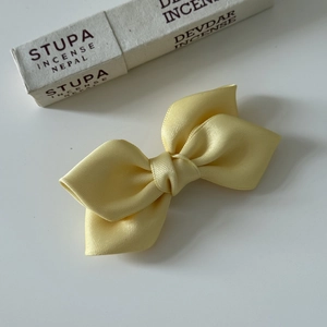 Elegant bright yellow satin layered bow hair clip for girls on clean white background