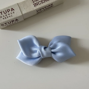 Elegant light blue satin bow hair clip with a stylish 3D double-layered ribbon design